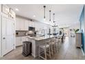 Bright kitchen with large granite island, stainless steel appliances, and an open floor plan at 34210 N Beeblossom Trl, San Tan Valley, AZ 85144