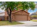 Attractive home with a two-car garage and lush front yard landscaping at 4053 W Quail Ave, Glendale, AZ 85308