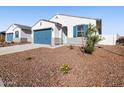 Charming single-story home showcasing a well-manicured front yard and a two-car garage at 41740 W Sonoran Trl, Maricopa, AZ 85138