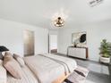 Cozy main bedroom featuring plush carpet, modern lighting, and ample closet space for storage at 4360 E Sierrita Rd, San Tan Valley, AZ 85143