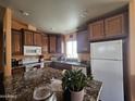 Well-equipped kitchen features sleek countertops, ample cabinet space, and modern appliances at 650 N Hawes Rd # 4326, Mesa, AZ 85207