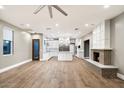 Open-concept living area showcasing a fireplace and seamless connection to the gourmet kitchen at 7309 E Rovey Ave, Scottsdale, AZ 85250