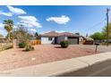 Single story home with low maintenance landscaping, tile roof, and dark garage door at 7715 N 23Rd Ave, Phoenix, AZ 85021