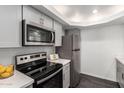 Close up of stainless steel appliances and gray cabinets in kitchen at 910 N Center St # 13, Mesa, AZ 85201