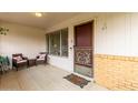 Cozy front porch with seating area offers a welcoming entrance to the home at 9625 W Oak Ridge Dr, Sun City, AZ 85351