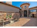 Front patio with outdoor seating, fireplace, and turret entry at 10649 E Saddle Blanket Trl, Gold Canyon, AZ 85118