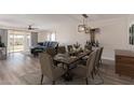 Beautiful dining room featuring a wooden table set for six guests with living room beyond at 11671 S Jokake St, Phoenix, AZ 85044