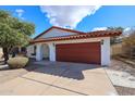 Inviting single-story home featuring a red tile roof and a spacious two-car garage at 14401 N 22Nd St, Phoenix, AZ 85022