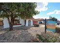 Quaint single-story home with desert landscaping and a red tile roof on a sunny day at 14401 N 22Nd St, Phoenix, AZ 85022