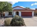 Lovely single-story home with desert landscaping, a red tile roof, and an attached two-car garage at 14401 N 22Nd St, Phoenix, AZ 85022