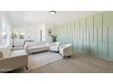 Bright living room with a modern accent wall, hardwood floors and comfortable seating arrangement at 1621 W Mulberry Dr, Phoenix, AZ 85015