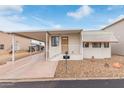 Charming single-story home with covered parking and cozy front porch in a well-maintained community at 17200 W Bell Rd # 77, Surprise, AZ 85374