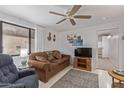 Cozy living room with plush seating, ceiling fan, and ample natural light for a comfortable atmosphere at 17200 W Bell Rd # 77, Surprise, AZ 85374