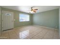 Inviting living room features neutral paint, tile flooring, and ample natural light at 1763 W Pepper Pl, Mesa, AZ 85201