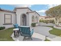 Inviting front porch with comfortable seating, perfect for enjoying the outdoors, and updated landscaping at 18327 N Summerbreeze Way, Surprise, AZ 85374