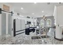 Modern kitchen boasts stainless steel appliances, granite countertops, and ample cabinet space at 18327 N Summerbreeze Way, Surprise, AZ 85374