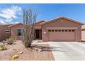 Charming home exterior with a well-manicured yard and desert landscaping at 19932 N Ibis Way, Maricopa, AZ 85138