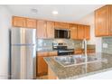 Modern kitchen featuring stainless steel appliances, granite countertops, and sleek cabinets at 200 E Southern Ave # 117, Tempe, AZ 85282