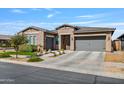 Beautiful stucco home featuring a multi-car garage, desert landscaping, and inviting curb appeal on a sunny day at 22744 E Stonecrest Dr, Queen Creek, AZ 85142