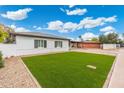 Well maintained front lawn on a single story home with gray shutters and covered parking at 3021 N Randolph Rd, Phoenix, AZ 85014