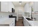 Bright white kitchen features modern appliances, white cabinets, quartz counters, and a pantry at 3021 N Randolph Rd, Phoenix, AZ 85014