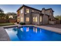 Inviting backyard showcasing a sparkling blue pool, lush lawn, and a putting green at 3737 E Donald Dr, Phoenix, AZ 85050