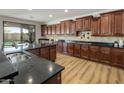 Spacious kitchen boasts custom wood cabinetry, granite countertops, and stainless steel appliances at 3737 E Donald Dr, Phoenix, AZ 85050