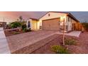 Beautiful home with a brick driveway, mature landscaping, and a spacious two-car garage at 3739 S 180Th Dr, Goodyear, AZ 85338