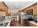Well-equipped kitchen with wood cabinets, granite countertops, and stainless steel appliances at 416 Leisure World --, Mesa, AZ 85206