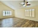 Bright and spacious bedroom with hardwood floors, a ceiling fan, and large windows with plantation shutters at 4349 E Encinas Ave, Gilbert, AZ 85234