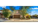 Charming two-story home featuring a brick driveway, desert landscaping, and a two-car garage at 4611 E Casitas Del Rio Dr, Phoenix, AZ 85050