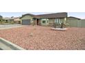 A cozy single-Gathering home featuring a two-car garage and desert landscaping at 6461 E Jensen St, Mesa, AZ 85205