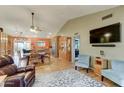 Open-concept living space featuring hardwood floors, recessed lighting, and a seamless flow into the dining and kitchen areas at 6461 E Jensen St, Mesa, AZ 85205