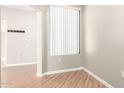 Bright bedroom with laminate flooring, large window, and neutral paint at 6900 E Princess Dr # 2124, Phoenix, AZ 85054