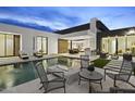 Backyard oasis featuring a sparkling pool with water features, fire pit, and luxurious outdoor seating at 7009 E Pasadena Ave, Paradise Valley, AZ 85253