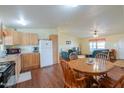 Bright kitchen with wooden cabinets, appliances, and adjacent dining area at 7209 N Maple St, Maricopa, AZ 85139