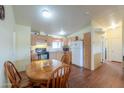 Open concept kitchen and dining area with wooden floors and ample natural light at 7209 N Maple St, Maricopa, AZ 85139