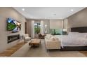 Spacious main bedroom suite featuring a fireplace, seating area and TV at 8307 E Gary Rd, Scottsdale, AZ 85260