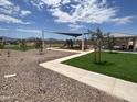 Well-maintained community playground featuring a covered play structure, swings, and picnic area, perfect for families at 9844 W Agora Ln, Tolleson, AZ 85353