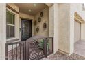 Inviting front porch features decorative sconces and an ornate security gate at 10717 E Tarragon Ave, Mesa, AZ 85212