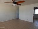 Bright living room with tile flooring and a ceiling fan at 11410 N 105Th Ave, Sun City, AZ 85351