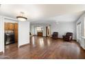 Open concept living room featuring wood floors, a fireplace, and lots of natural light at 1213 W Esplanade St, Mesa, AZ 85201