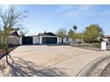 An inviting home featuring a modern garage door and a well-maintained desert landscape at 13216 N 48Th Pl, Scottsdale, AZ 85254