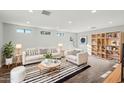 Cozy living area with a comfortable seating arrangement, striped rug, and built-in bookshelves at 13216 N 48Th Pl, Scottsdale, AZ 85254