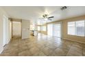 Bright and airy living room showcasing tile flooring, an open floor plan, and seamless access to the kitchen at 1406 W Charleston Ave, Phoenix, AZ 85023