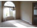 Carpeted dining room features large windows with decorative chandelier at 14648 S 25Th St, Phoenix, AZ 85048