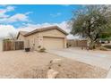 Single-story home featuring a two-car garage with a desert landscape yard at 14686 W Clarendon Ave, Goodyear, AZ 85395