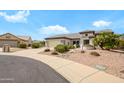 Well-kept home on a cul-de-sac, featuring a two-car garage, desert landscaping, and a welcoming facade at 15750 W Linksview Dr, Surprise, AZ 85374