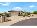 Charming single-story home with a well-maintained yard, showcasing a spacious driveway and a two-car garage at 15750 W Linksview Dr, Surprise, AZ 85374