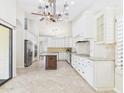 Bright and airy kitchen with white cabinetry, granite countertops, and stainless steel appliances at 1635 W Wisteria Dr, Chandler, AZ 85248